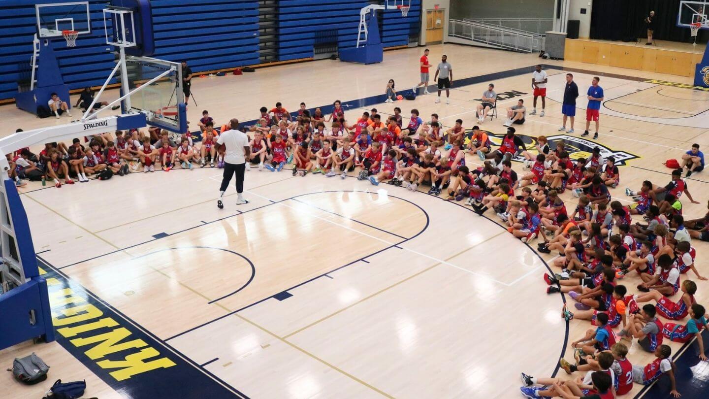 Campers sitting on the court for instruction